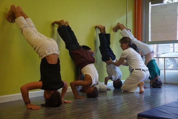 Students work on their head stands in Capoeira class.