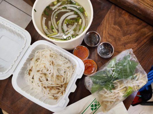 Sliced beef pho with extra Sriracha and hoisin sauce