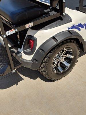 Rear of EZ-GO golf cart, scratch above wheel