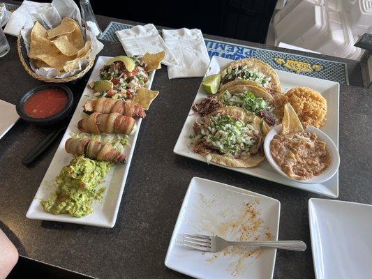 Carnitas tacos cilantro and onions dinner   On the right. Appetizer guacamole, bacon wrapped peppers poppers , ceviche on the left