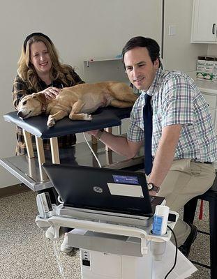 Drs Richard and Candice Blake performing an echocardiogram to evaluate their pup, Sly's heart.