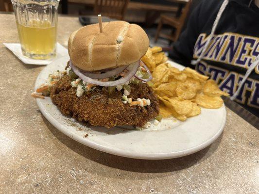 Special - brined chicken sandwich with crispy pickles, mayo, coleslaw, and red onions. Served with chips.