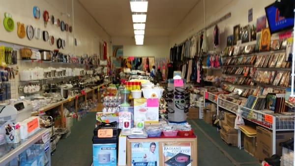 It's a very humble store, with various electronic appliances, kitchen supplies, kitchen utensils (left), and clothing items (right)