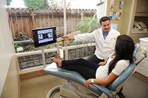 Dr. Halabo speaking with a patient at his dental office in Chula Vista, CA.