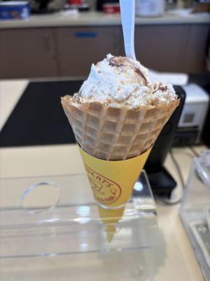 Coconut macadamia ice cream in a waffle cone