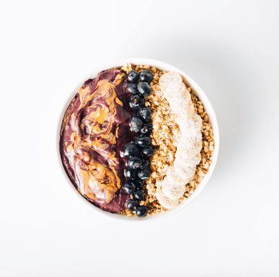 'PB Power' Açaí Bowl; topped with Hemp Granola, Bananas, Blueberries, choice of Agave or Honey Drizzle. *PB swirled into the Açaí Base