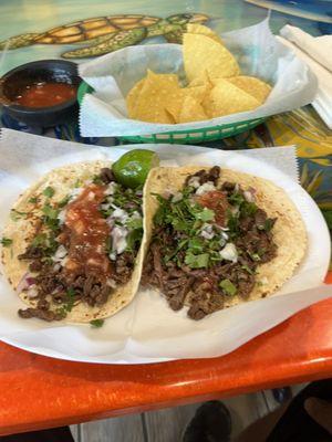 Steak tacos. On flour tortillas. Onion and Cilantro.