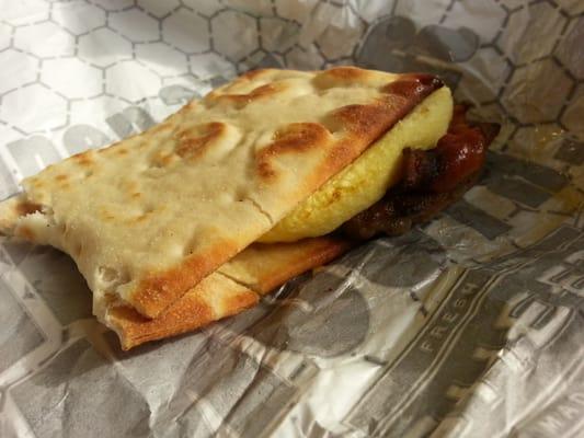 Flatbread, sausage bacon and egg sandwich