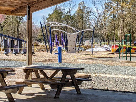 They're are shaded picnics tables for you to eat at while your kids play nearby.