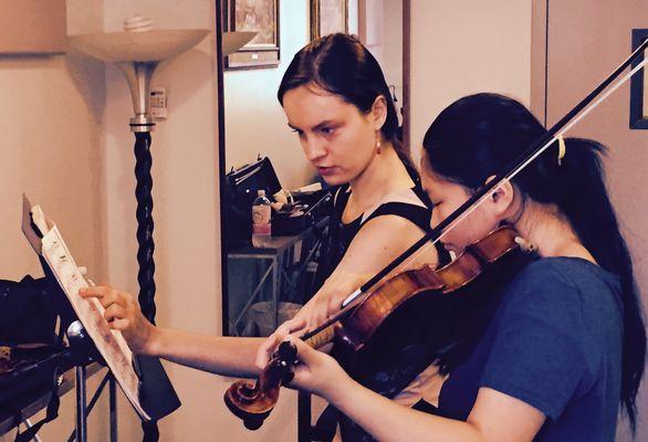 Kinga Augustyn in teaching session with violin student.