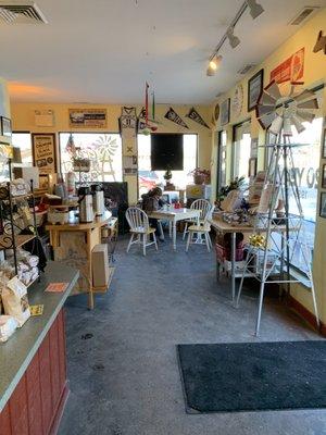 Inside view of bakery with small seating area in background