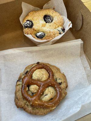 A blueberry muffin and a pretzel chocolate chip cookie