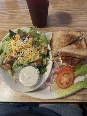 The Club Sandwich with a salad.