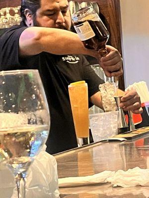 The bartender pouring heavy drinks