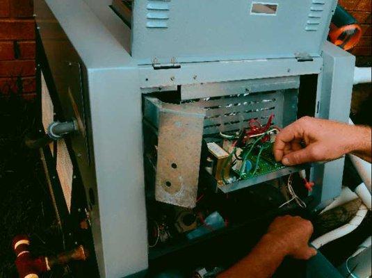 Head tech checking out a pool heater control board.