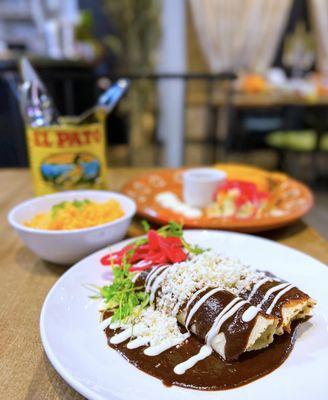 Enchiladas de Mole: Chicken taquitos w/ Oaxacan mole negro, crema, queso fresco, onions, mexican rice | $15