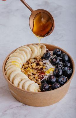 Acai Bowl. Organic Acai, Granola, Banana, Blueberries, Coconut Flakes, Honey Drizzle