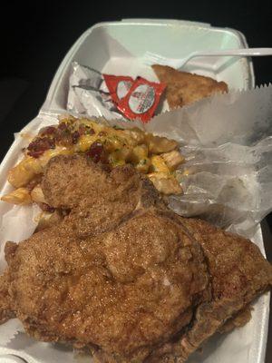 Fried pork chops , loaded fries and you can't see it but I ordered a side of Cajun rice and they also give you a piece of cinnamon toast