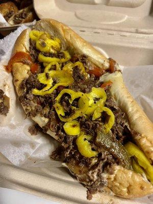 Philly Cheesesteak with onions, sweet peppers, banana peppers, American cheese, provolone, mayo, ketchup