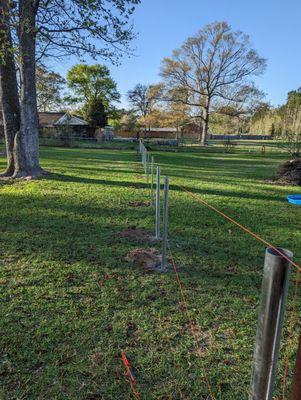 Posts set and concreted in.