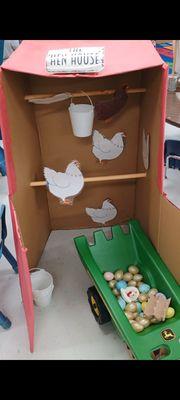 Toddlers enjoyed pushing the wheelbarrow and making plush chickens lay eggs at the Hen House on Farm Day at Mommy/Daddy and Me!