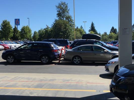 Cars parked close but with space with poles in-between