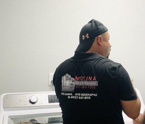 A team member from Molina's explaining the importance of clean dryer vents.