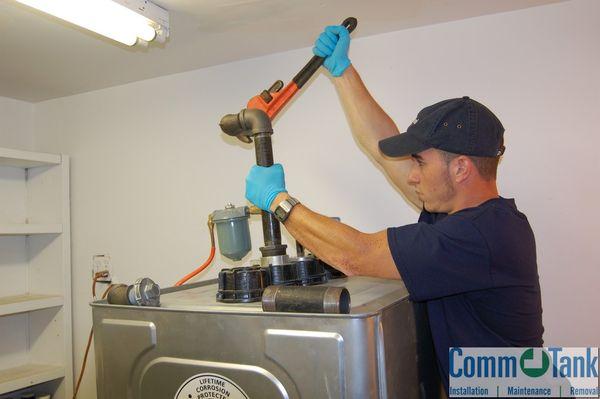 CommTank technician installing fuel line for a Roth oil tank.