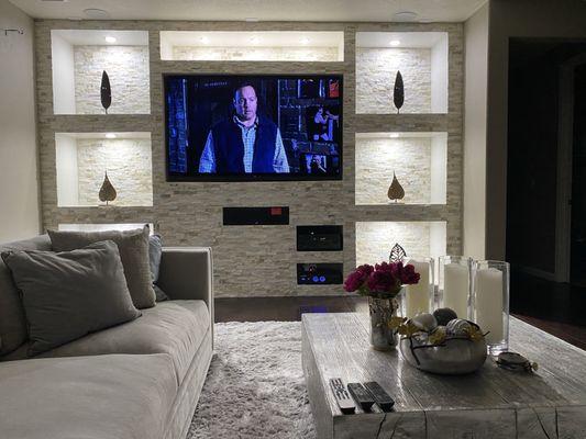 Entertainment wall constructed with stone and new lighting