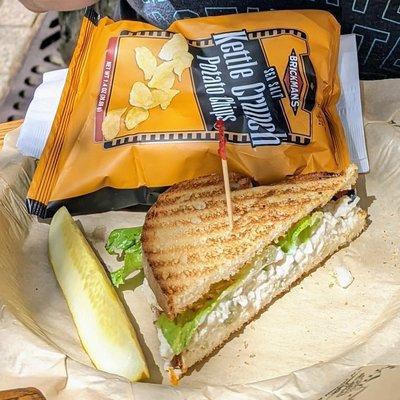 Chicken salad sandwich, chips and a pickle