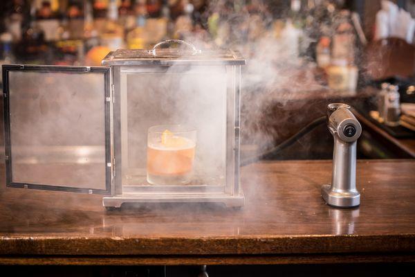 A twist on a classic cocktail: Smoked old fashioned: smoked with cherry-flavored wood chips