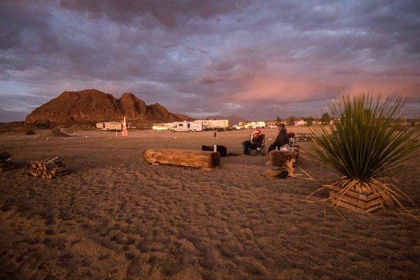 Community area with fire pit, grill, and games.