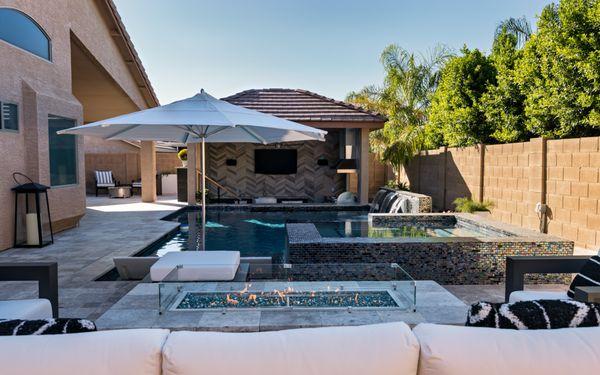 A lot of entertaining in this little yard, sunken bar in pool, raised spa, waterfeature, firepit, custom pergola.