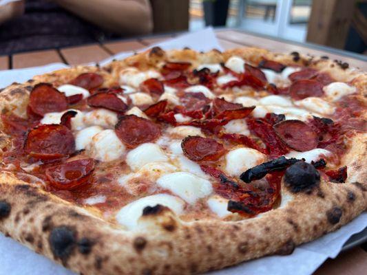 Pepperoni pizza with sun dried tomatoes.