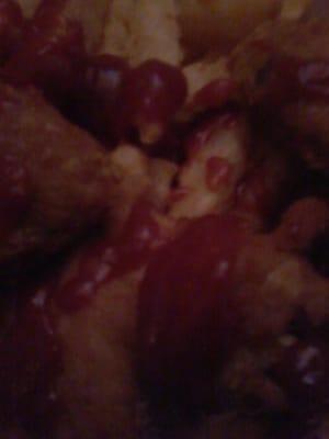 Chicken wings and French fries drizzled with ketchup all over.  Just the way I like!