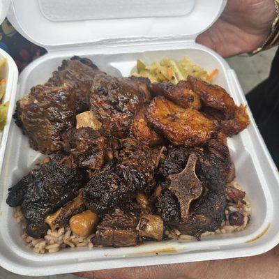 Oxtail, Jerk Chicken  combo plate with Beans and Rice, Plantains and cabbage. DELICIOUS!!