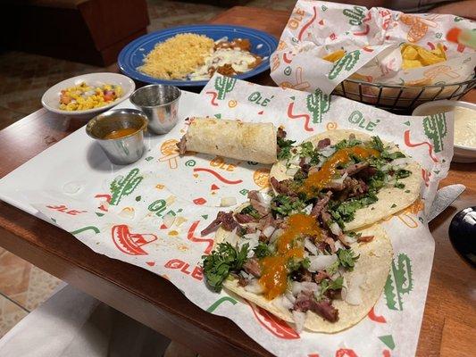 Brisket tacos, refried beans, rice, Mexican corn, tortilla chips. The red chili sauce was great.