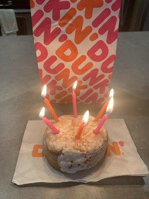 Vanilla cream filled powdered donut (with birthday candles)