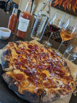 Pepperoni wood fried pizza (with a glass of Hacienda Crossing Pinot noir and rosé behind)