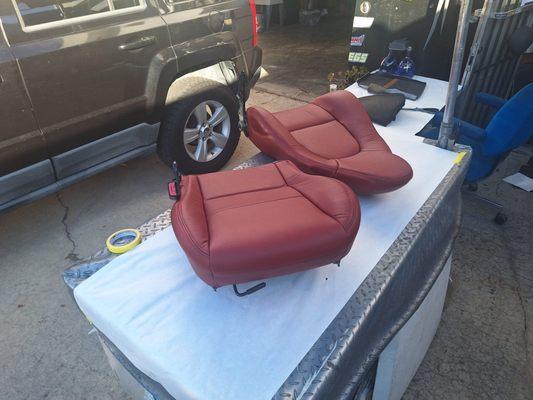 Leather seat skins being installed.