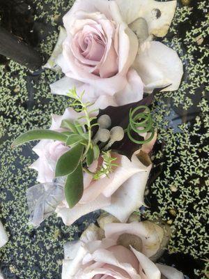 Boutonnière floating on a rose for a pose.