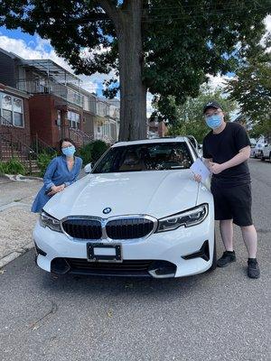 A happy couple with their custom ordered 2021 BMW 330i xDrive!