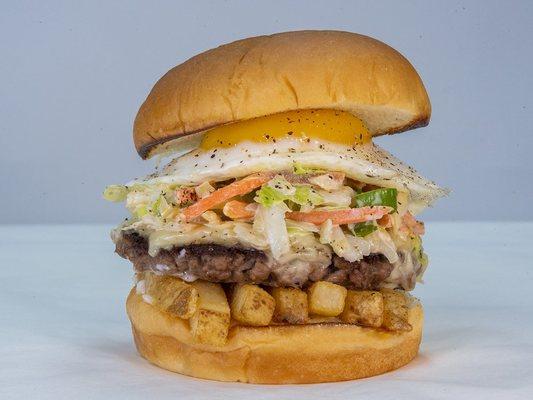 The "Slaw Burger": Impossible patty, white American cheese, fries, slaw, fried egg, and mayo, served on King's Hawaiian bread