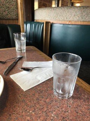 Empty water glasses and a bill right as our breakfast came