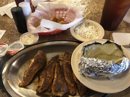 Blackened catfish with baked potato and coleslaw