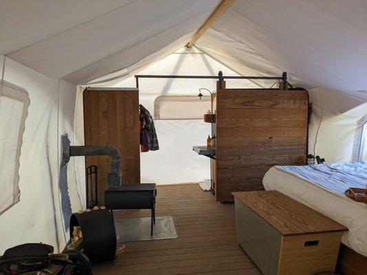 View from the front of tent back towards the shower, sink and toilet area.