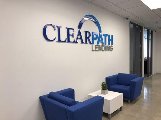 Cute blue chairs and pretty logo in the lobby area.