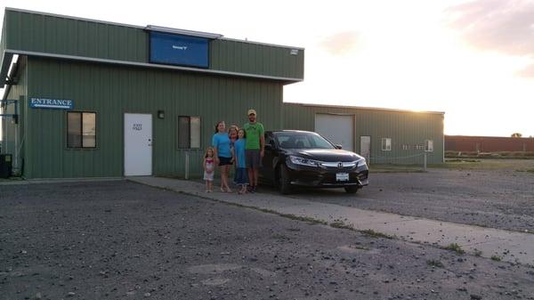 Derek,the owner with his family in front of shop.