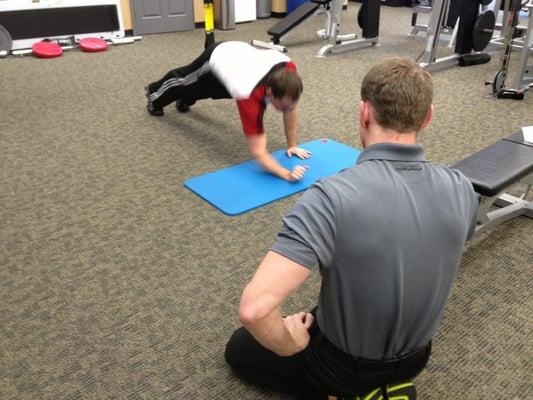 Strength and Conditioning Specialist Matt Mangol keeping a watchful eye on both the form and effectiveness of these planks.