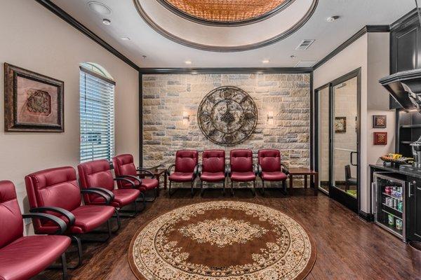 Waiting area with snack bar, big screen TV, kids corner, and fireplace.